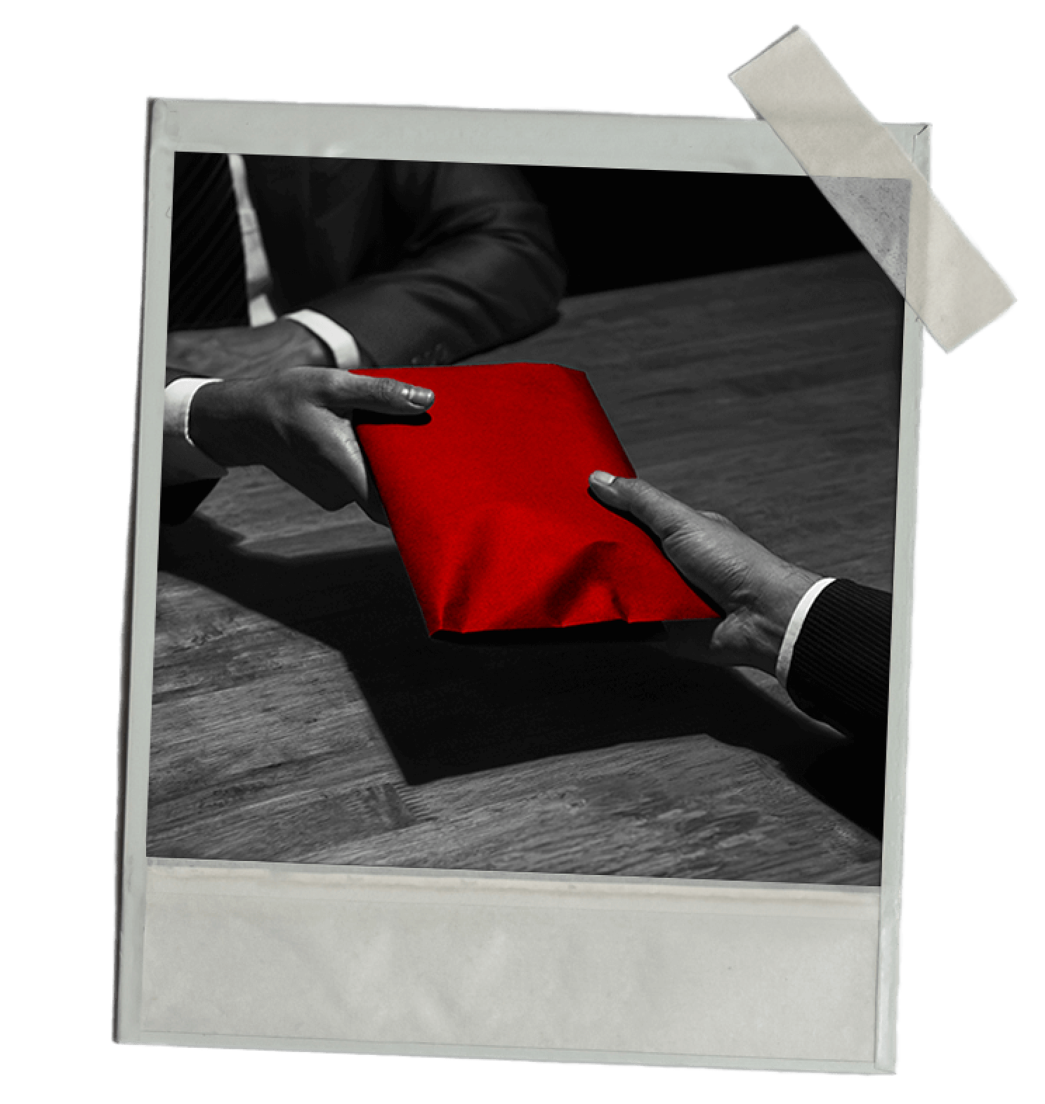 An exchange of mystery: two hands, one presenting a red, wrapped gift, captured in a timeless black and white photo with a hint of color.