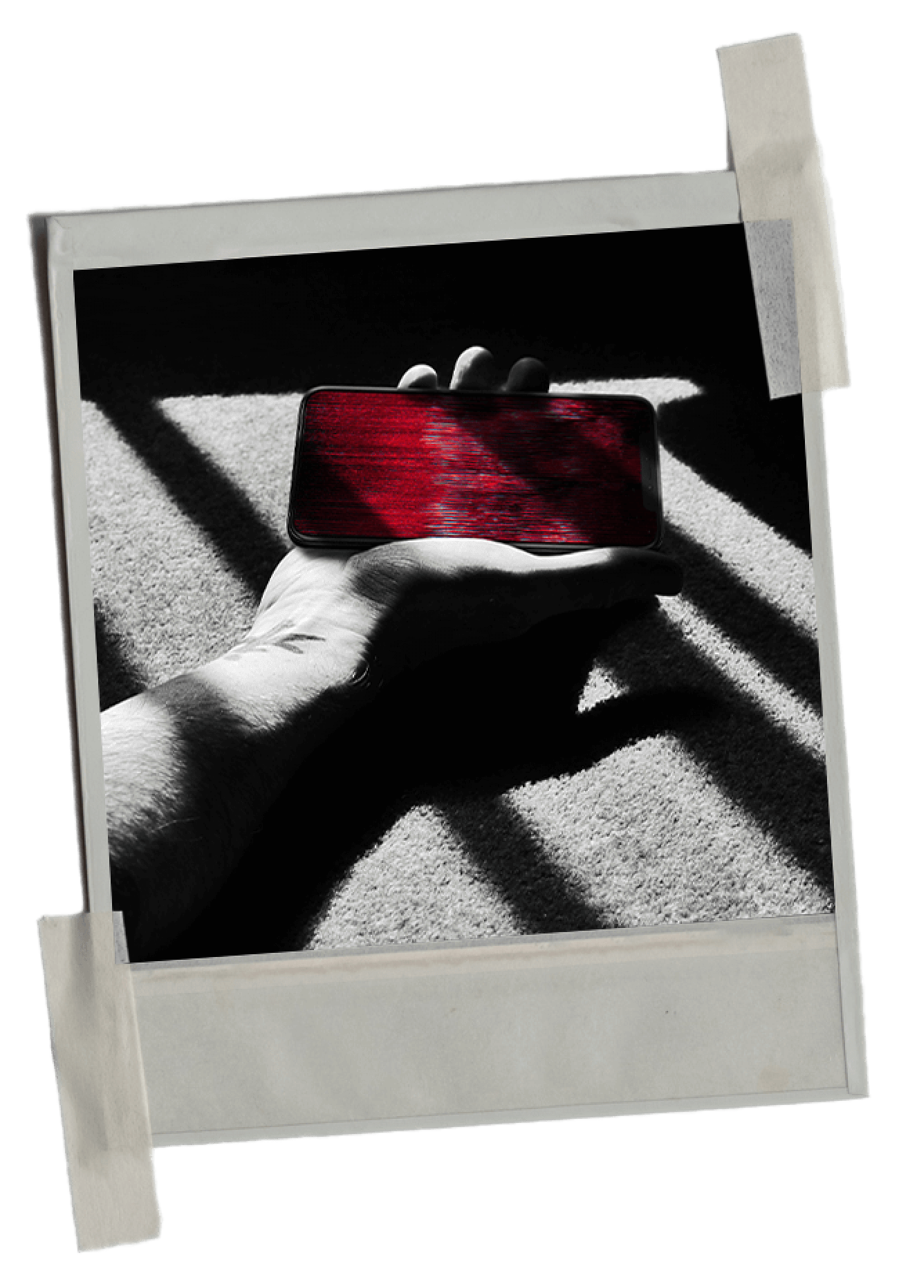 A hand emerging from the shadows, gripping a smartphone with a red screen, framed against a contrasting backdrop of light and dark stripes, captured within a polaroid-style border with adhesive tape at the edges.